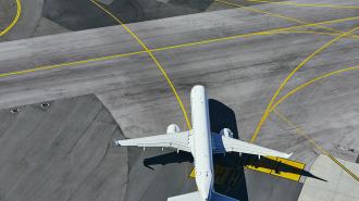 aerial view of airport with plane taxiing