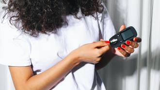 Woman checking her blood sugar level.