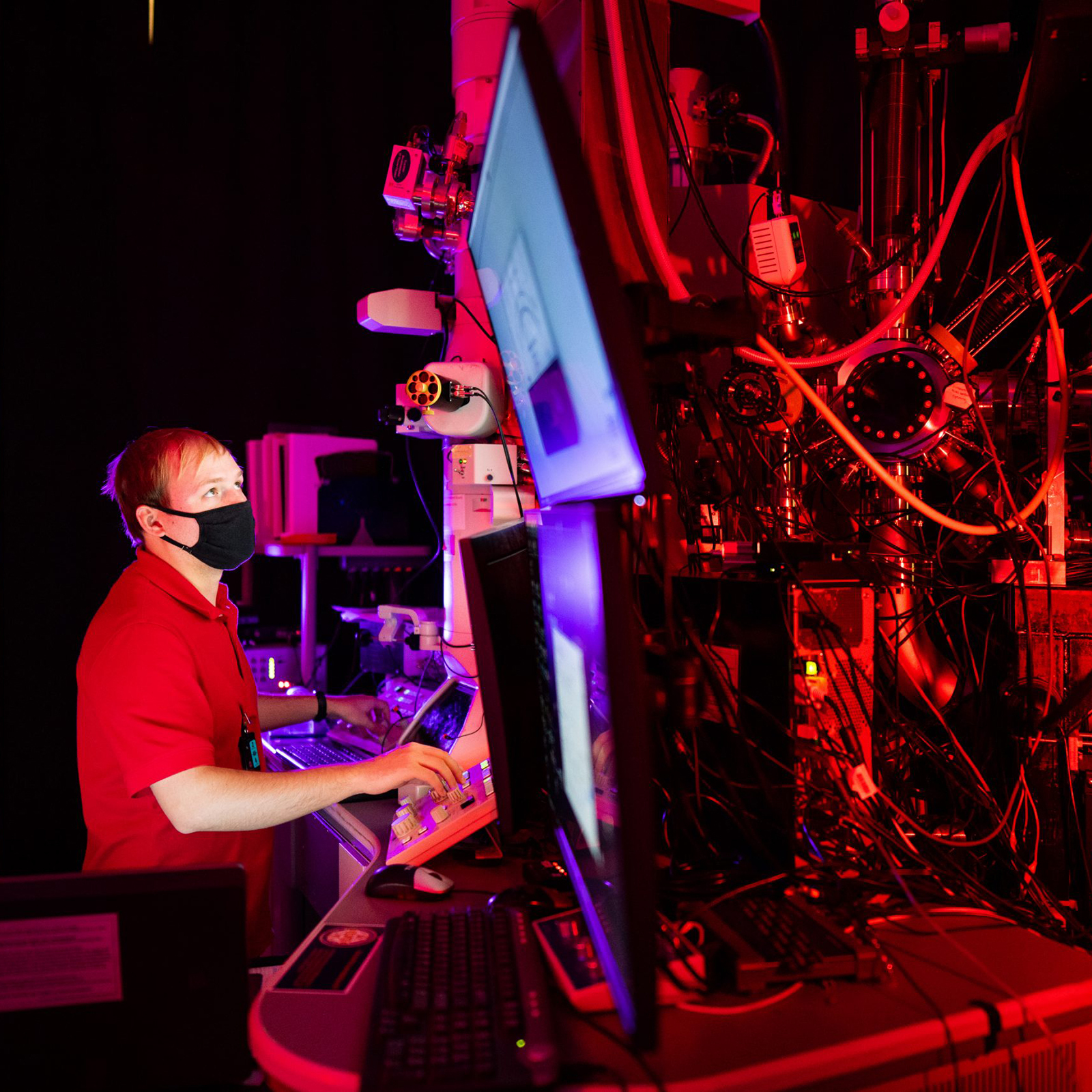 A man in a red shirt in a science lab