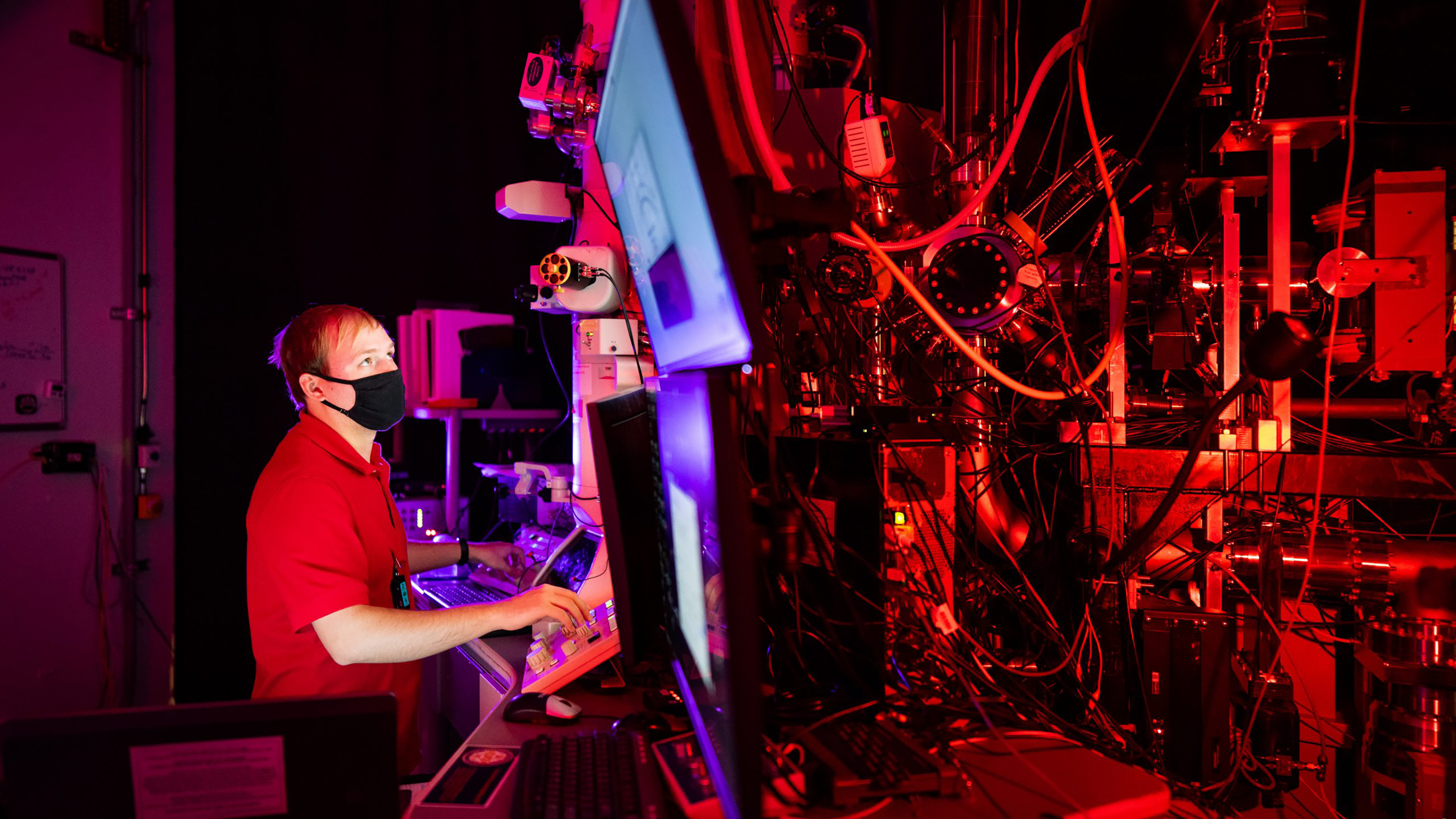 A man in a red shirt in a science lab