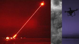 an image of the laser weapon firing a red beam at an object in the sky