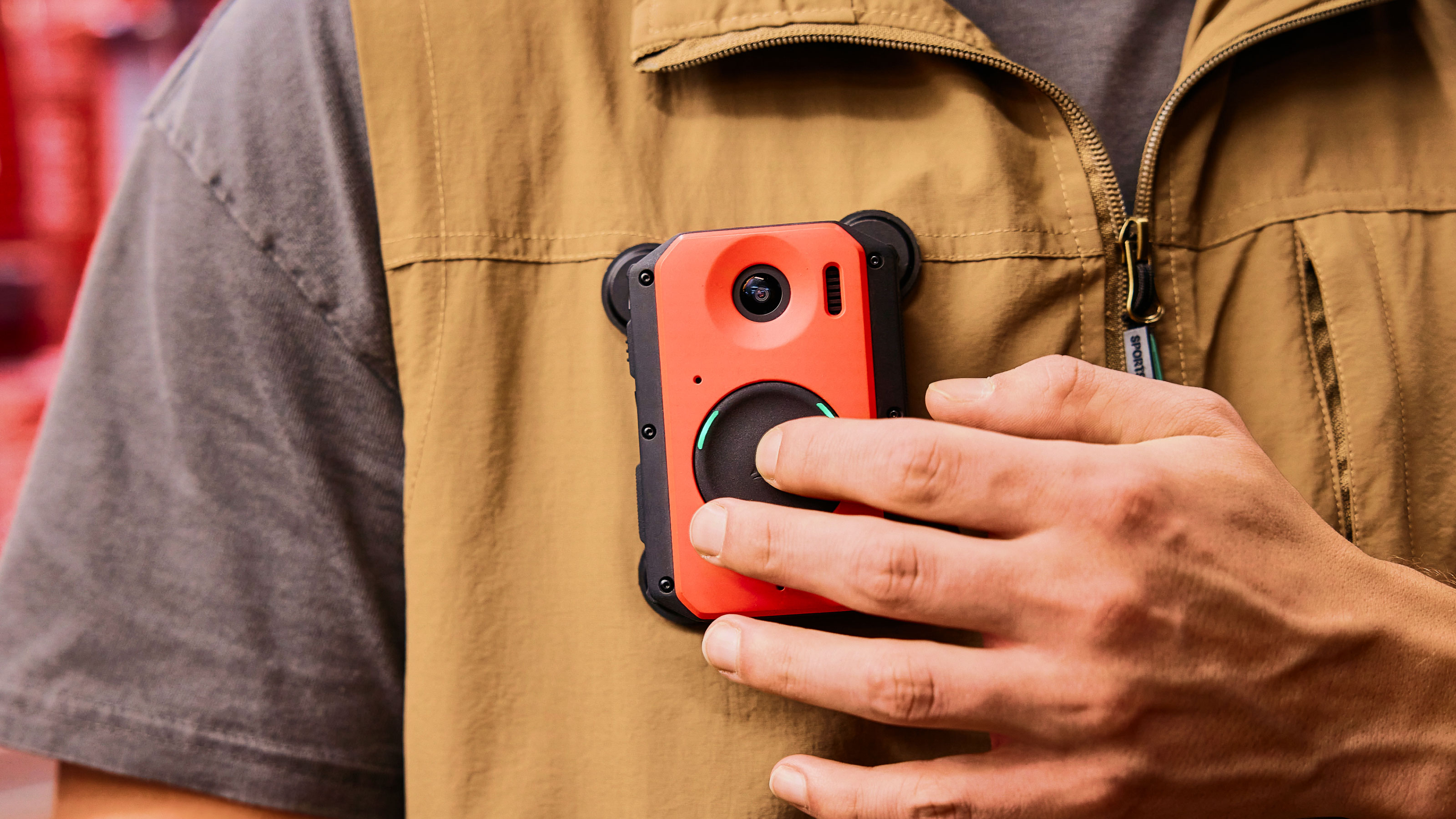 A man holding a cell phone in his pocket.