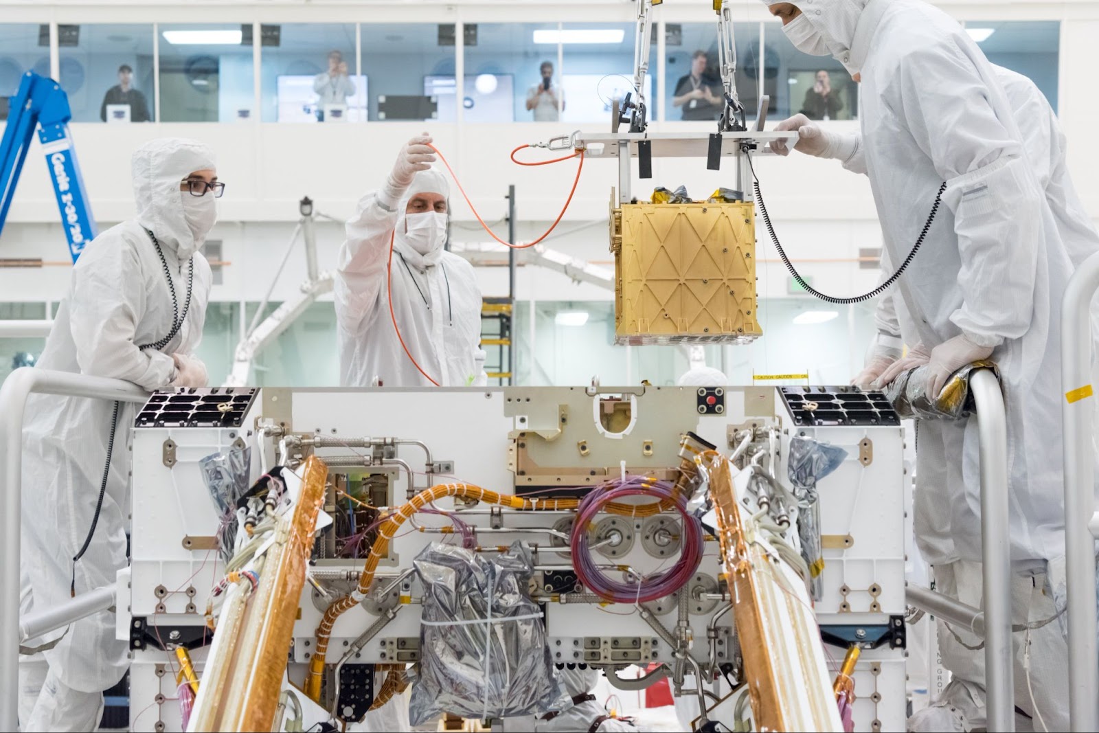 a golden box being lowered into a spacecraft