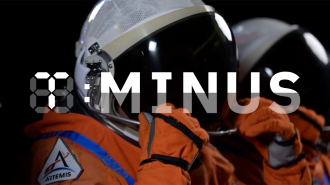 Two astronauts wearing orange spacesuits and helmets are preparing for a mission, geared up to explore the lunar surface. The text "T-MINUS" is overlaid on the image.