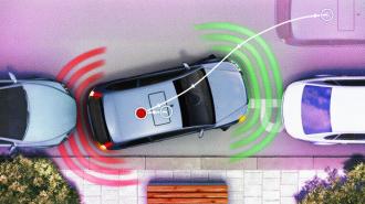 Aerial view of a car using semi-autonomous driving automation to parallel park between two other cars. Red and green sensor indicators display the car's proximity to obstacles while guiding its reverse parking.