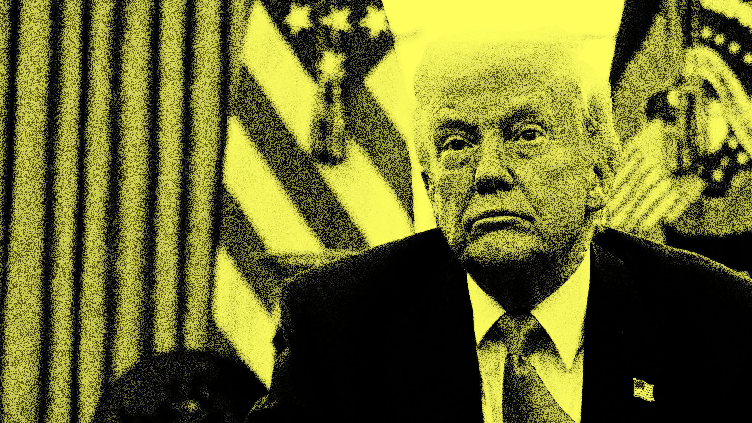 A man in a suit sits in a room with American flags behind him. The image is in high contrast with a yellow tint.